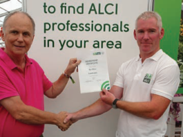Barry Moore being presented with his membership certificate by Ross Carew, executive secretary ALCI