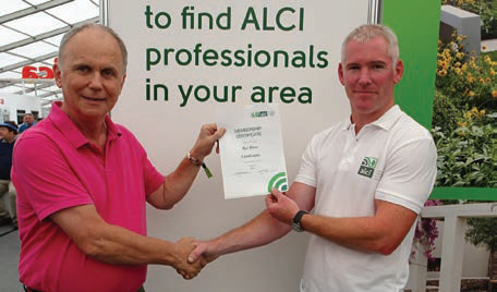 Barry Moore being presented with his membership certificate by Ross Carew, executive secretary ALCI