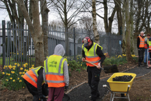 HARD AT WORK: COMMUNITY AND STUDENTS INSTALL A NEW GARDEN PATH