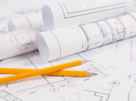 Pencils and paper ?Engineering house drawings and blueprints.