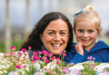 Woman and child behind flowers