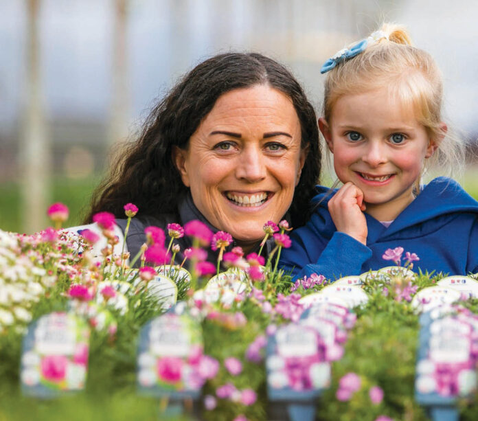 Woman and child behind flowers