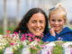 Woman and child behind flowers