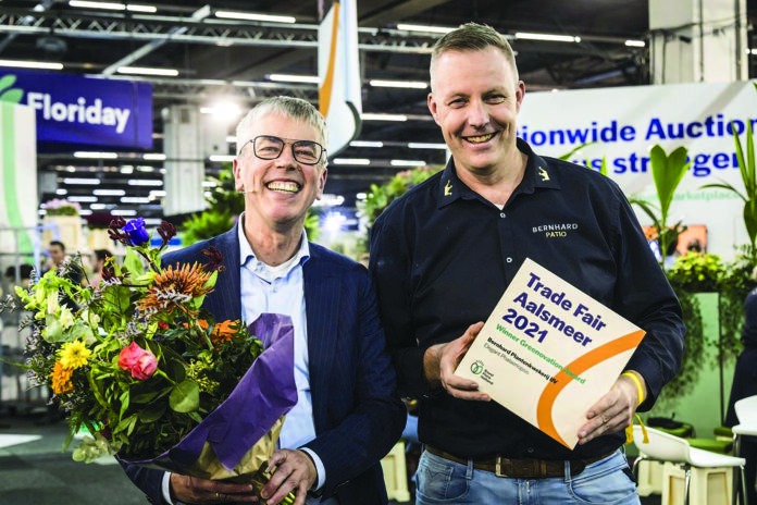 BRAM BERNHARD TOOK TO THE HOLLAND HOUSE STAGE AT TRADE FAIR AALSMEER ON WEDNESDAY, 3 NOVEMBER 2021, TO ACCEPT THE GREENOVATION AWARD FROM ROYAL FLORAHOLLAND BOSS STEFAN VAN SCHILFGAARDE